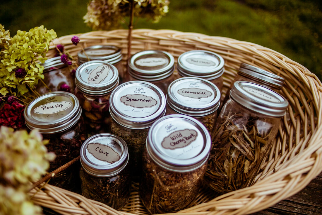 A basket holds jars of herbs.